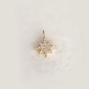 Solid Gold Starburst Cut Out Charm With CZ